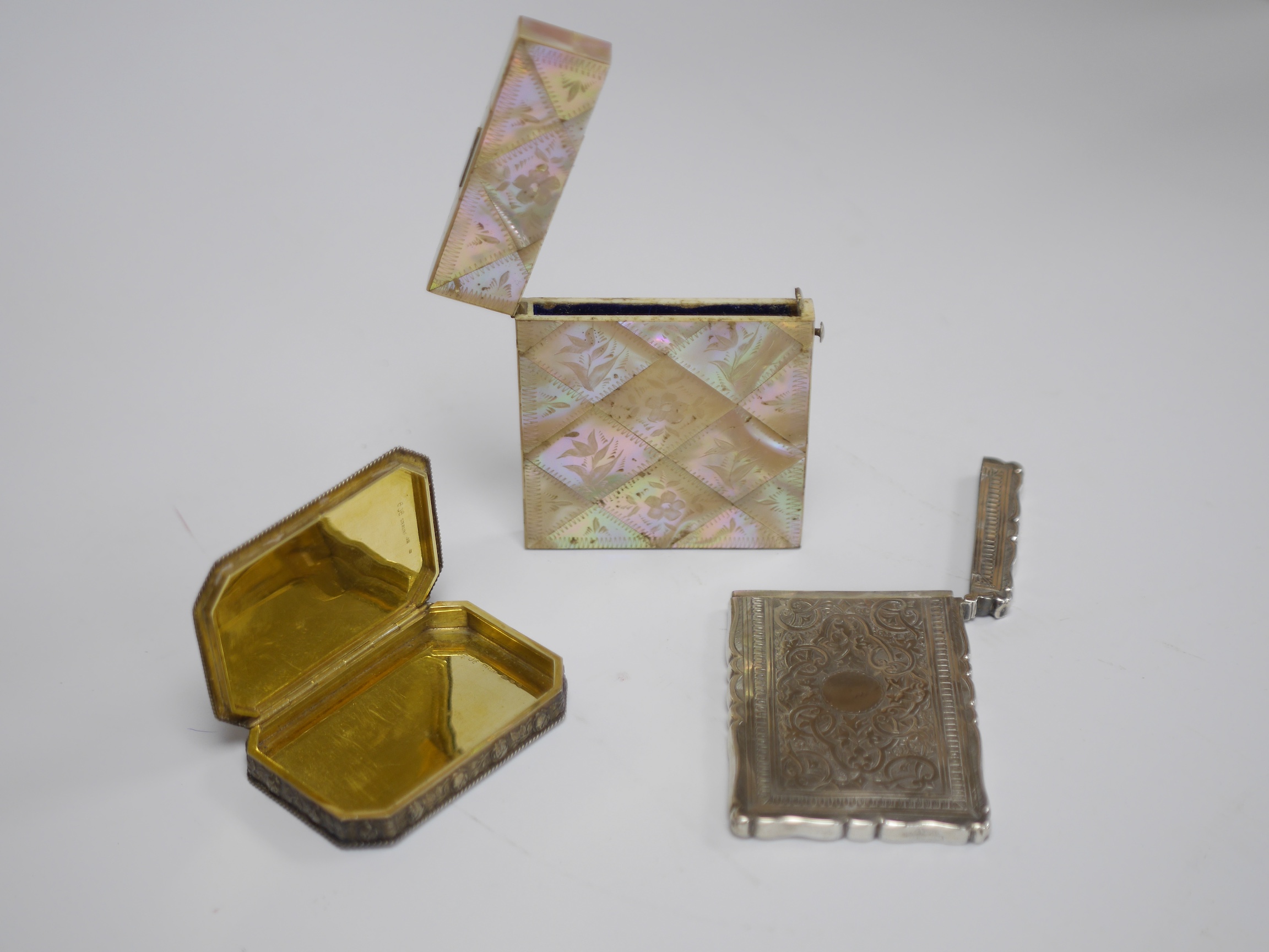 A continental Art Deco sterling and two colour enamel octagonal snuff box, maker, LW, 78mm, together with a Victorian engraved silver card case by Frederick Marson, Birmingham, 1879 and a mother of pearl card case. Condi